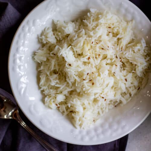cooked cumin seed rice in white bowl