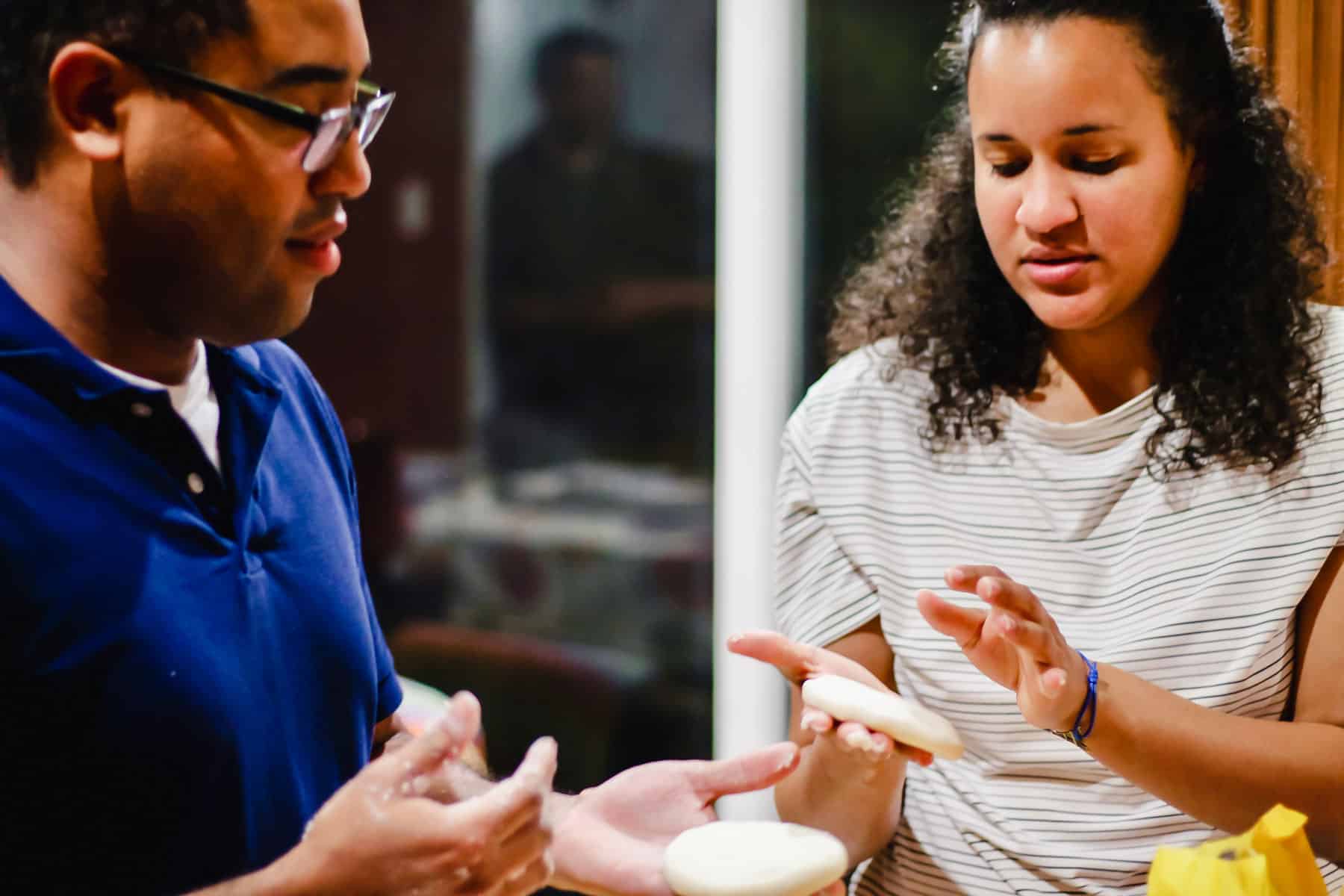 Venezuelan Daniel David Vargas Rengifo and his Cuban wife Yiselis Vargas teaching Abi how to make arepas