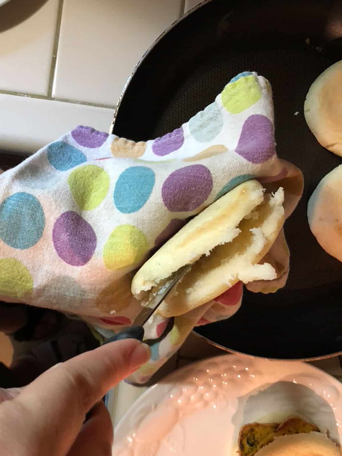 Process step 17 hold arepa with kitchen towel and slice 3:4 open to fill with arepa filling