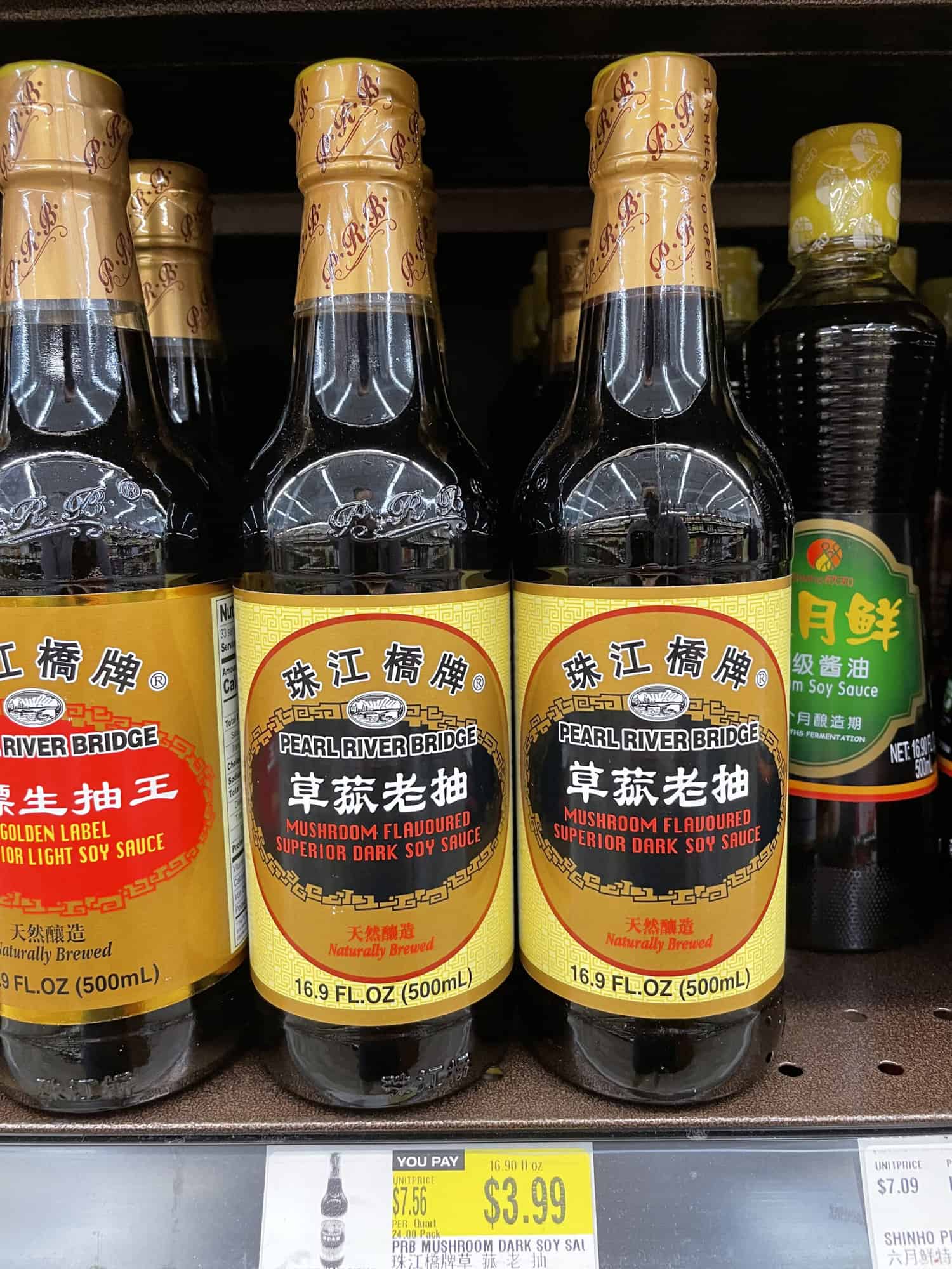 Bottles of mushroom-flavored superior dark soy sauce by Pear River Bridge at H Mart