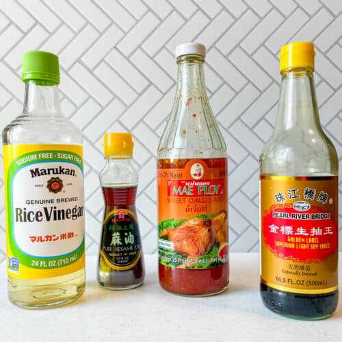 bottles of rice vinegar, toasted sesame oil, sweet chilli sauce and soy sauce on counter
