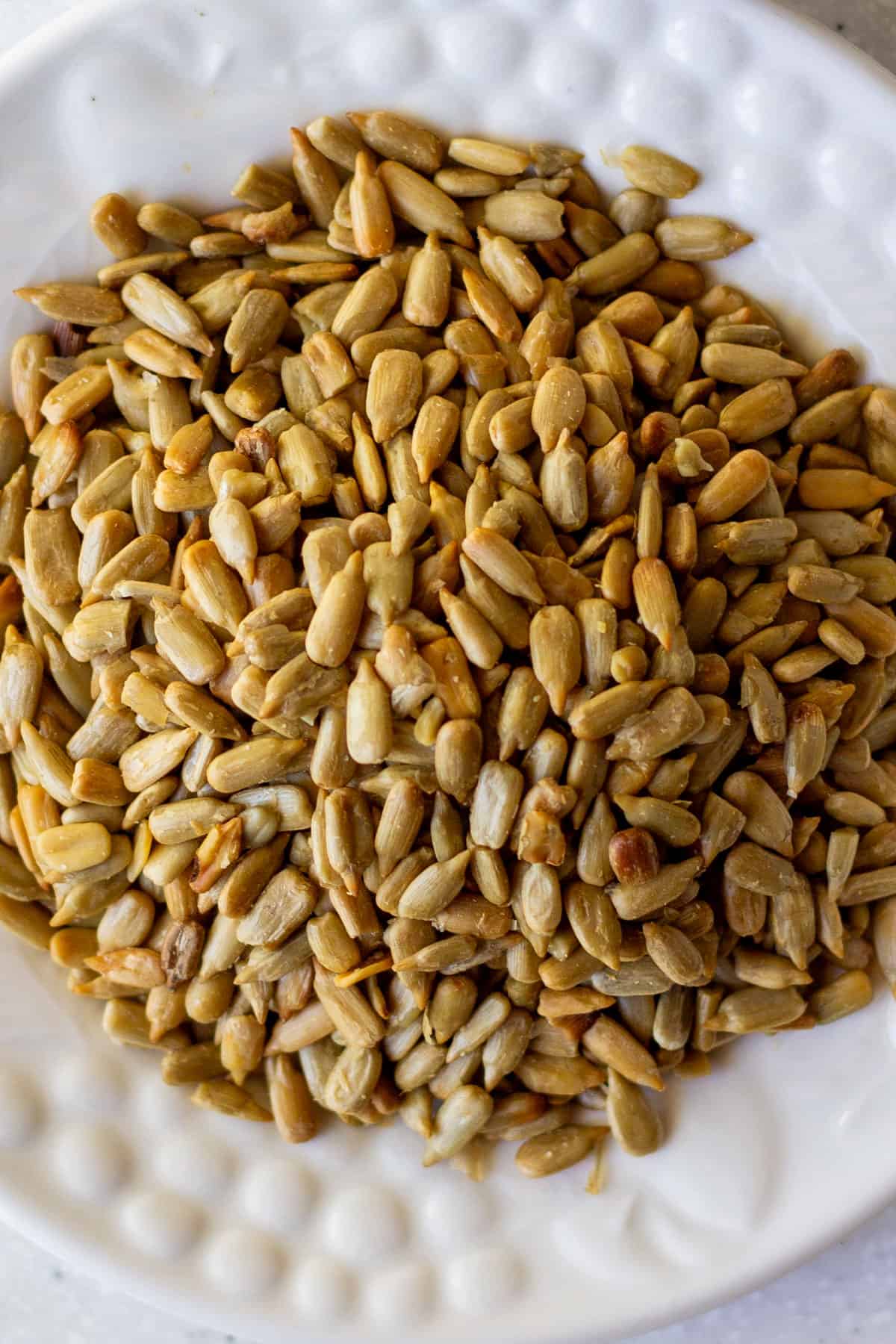 raw sunflower seed kernels on white plate