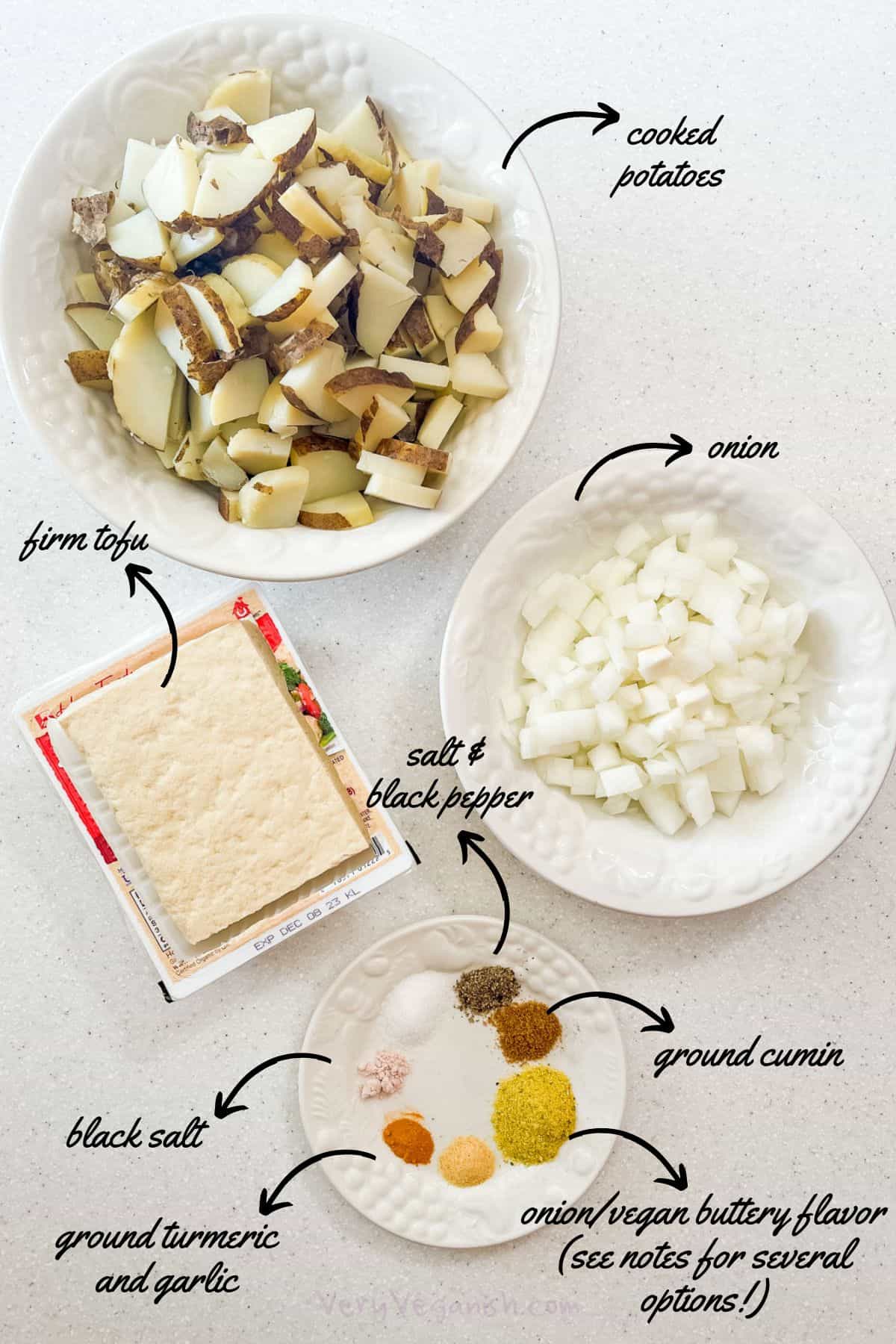 Ingredients for Potato and Egg Vegan Breakfast Tacos: steamed russet potatoes, onion, firm tofu and seasonings: salt, black pepper, ground cumin, black salt, turmeric, garlic and vegan onion/buttery flavor