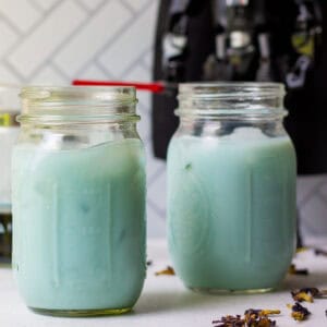 two glasses of blue milk with darth vader figure standing in the background