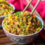 bowl of vegetable fried rice with no egg on bamboo mat