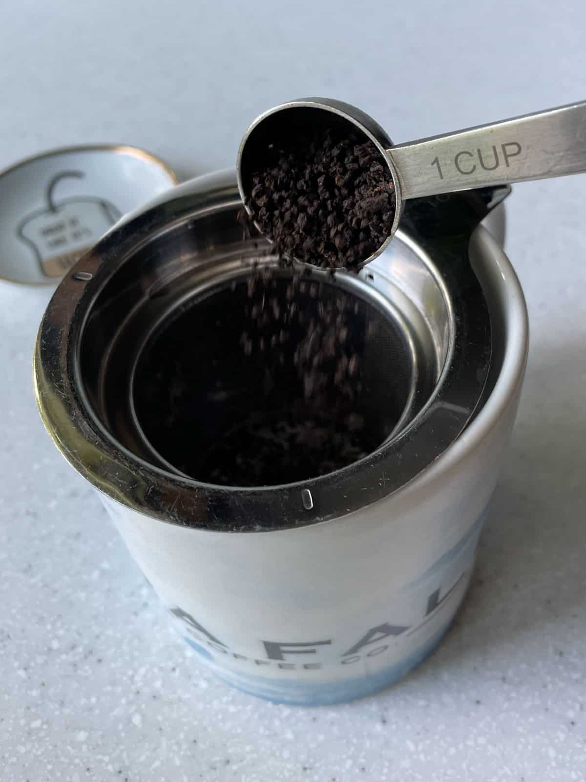 pouring loose leaf tea into infuser