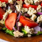 closeup of greek salad with tofu feta cheese crumbled on top