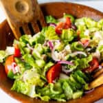 big bowl of vegan greek salad with utensils