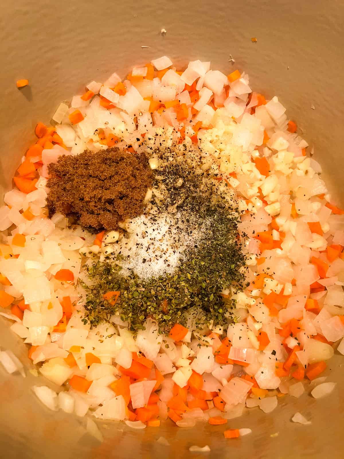 adding basil, salt, pepper and brown sugar to vegetables