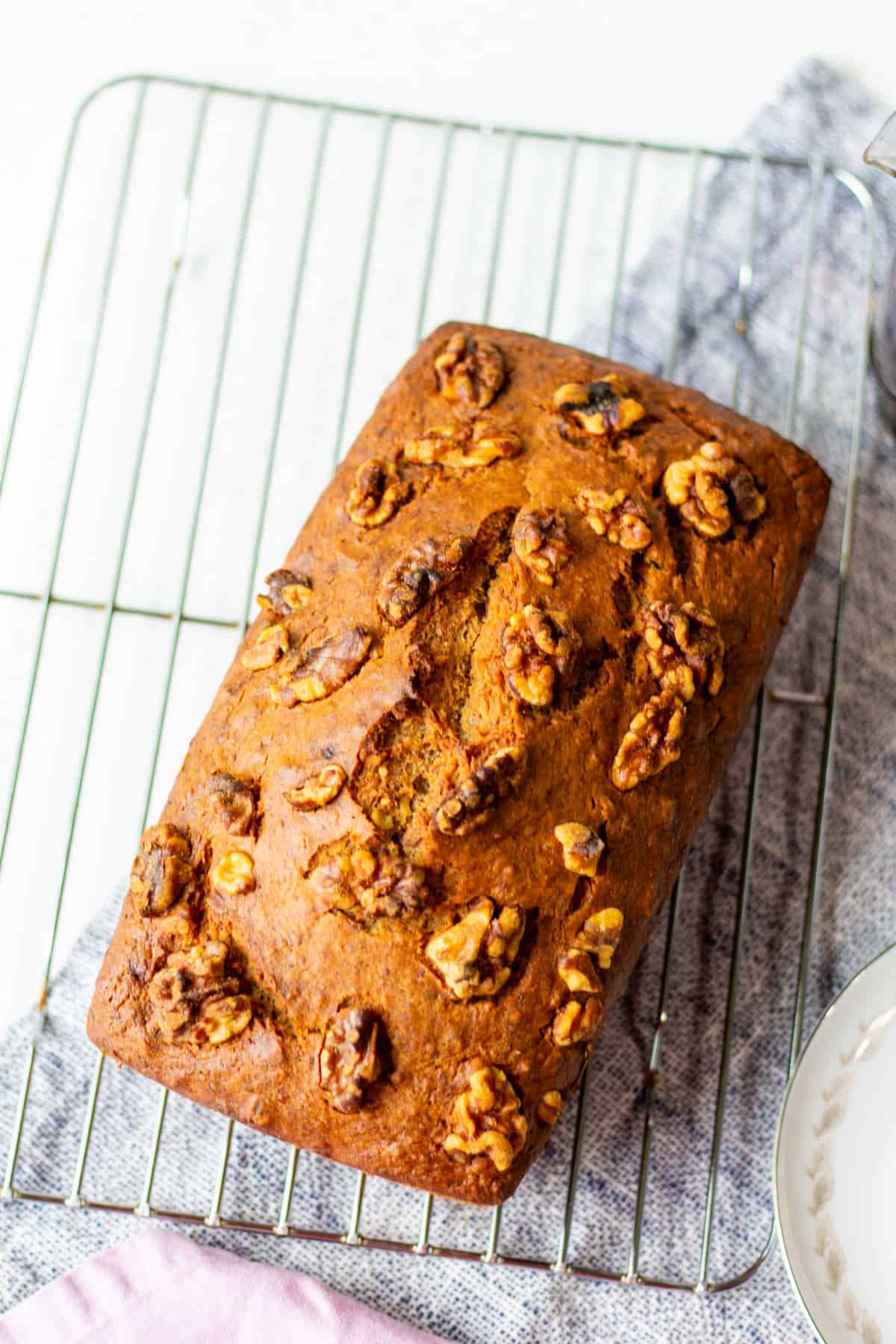 loaf of vegan banana nut bread on a cooling rack