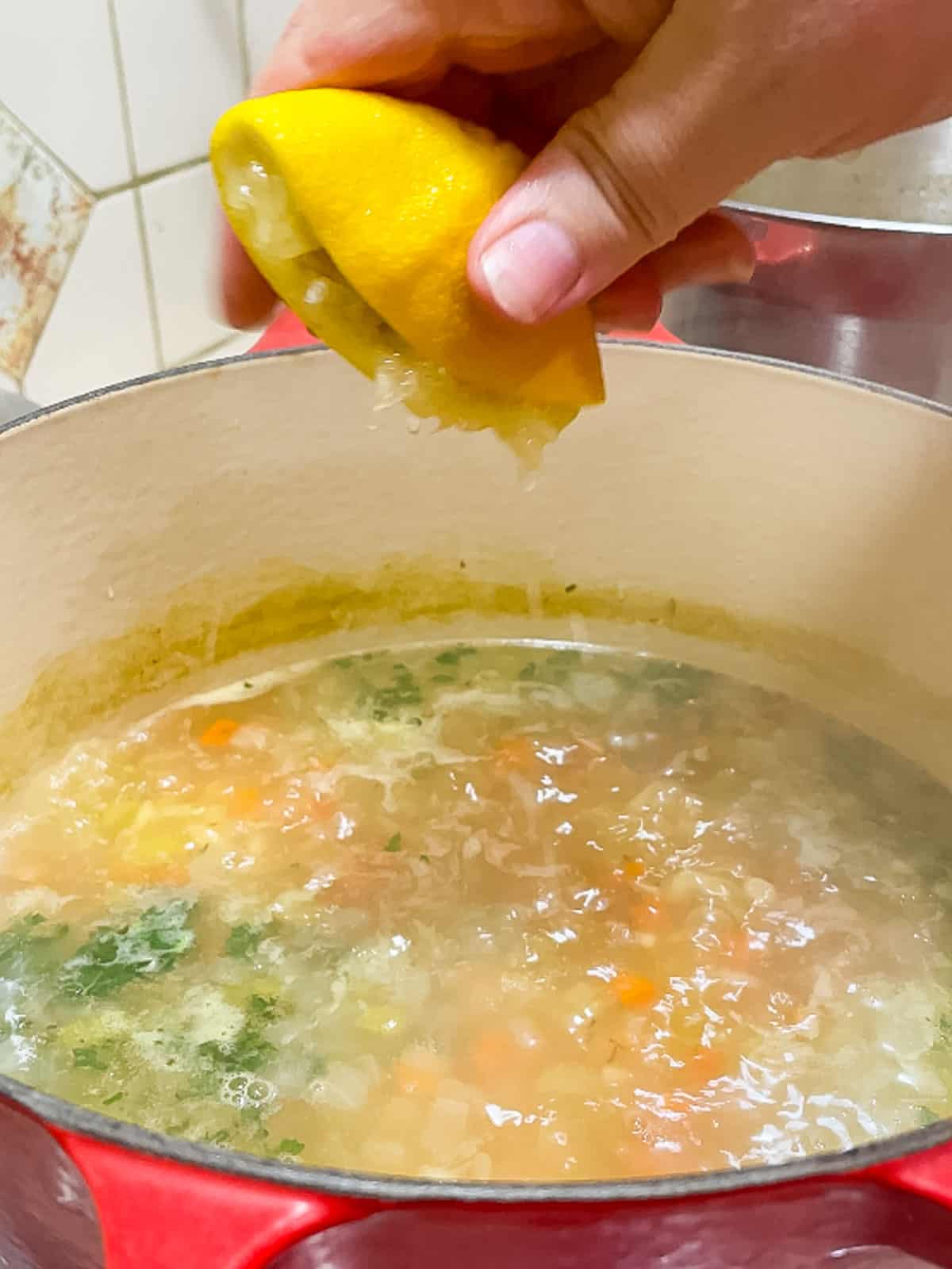 squeezing lemon juice into soup