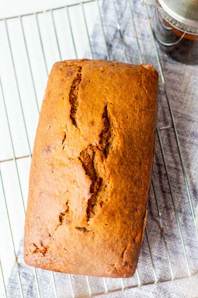 baked loaf of banana bread on cooling rack