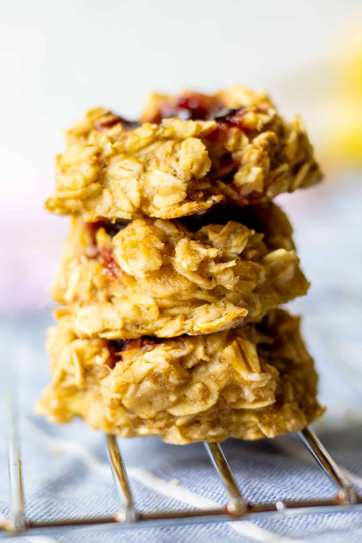 three thumbprint cookies stacked on a cooling rack