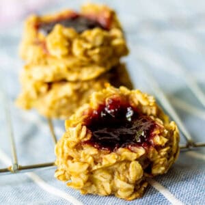 jam-filled thumbprint oat cookies on cooling rack