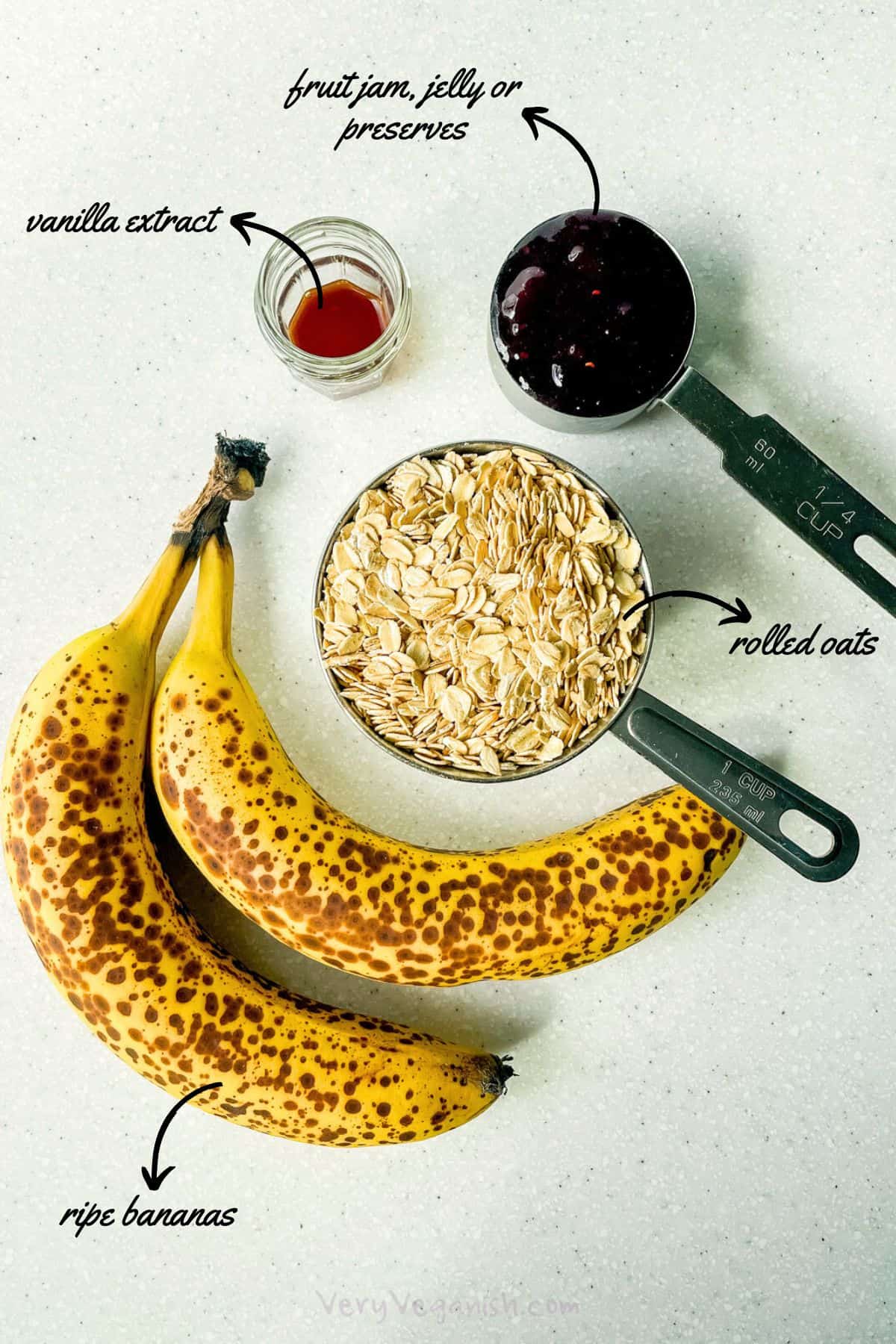 Ingredients: 2 ripe bananas, rolled oats, fruit jam and vanilla extract on counter