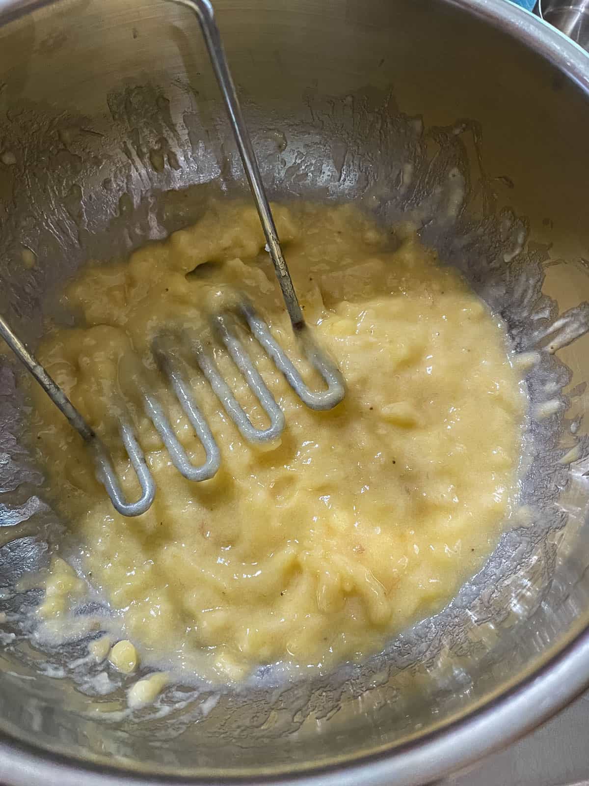 mashed banana in metal bowl