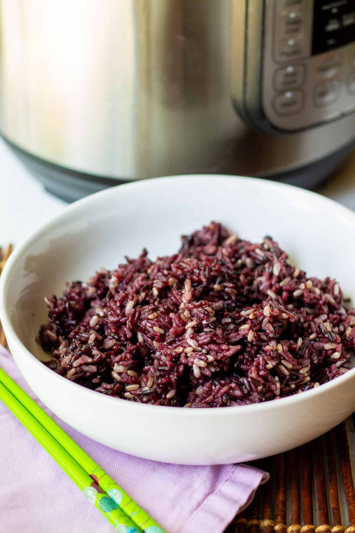 white bowl of cooked purple multigrain sushi rice