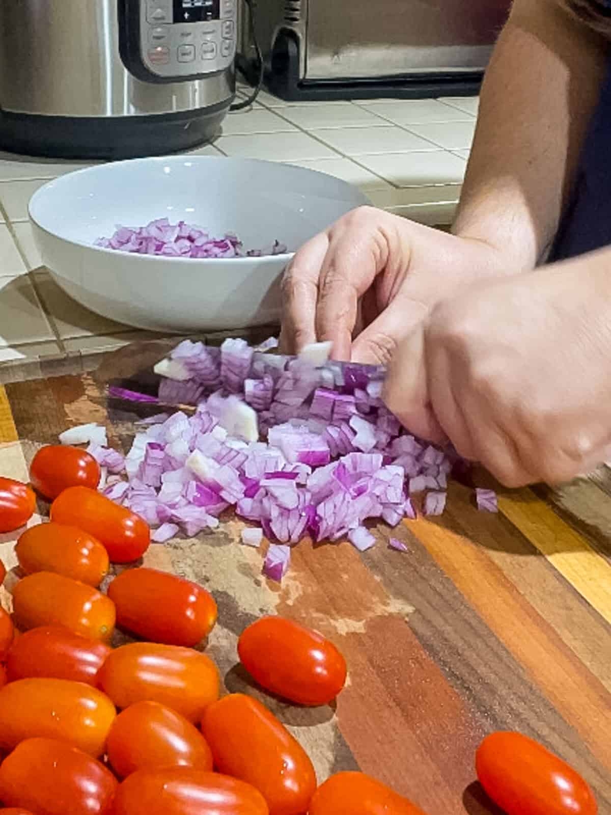 Step 1 - mincing red onions on cutting board