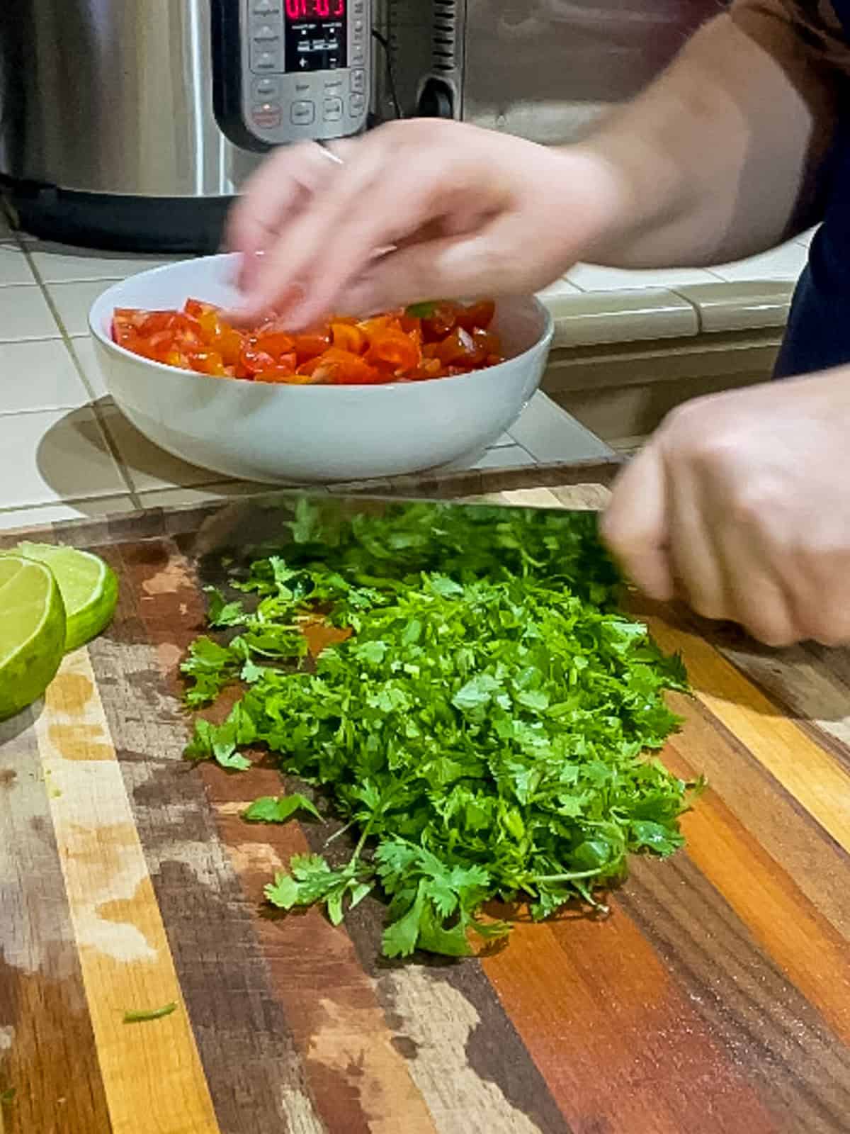 Chopping fresh cilantro on cutting board