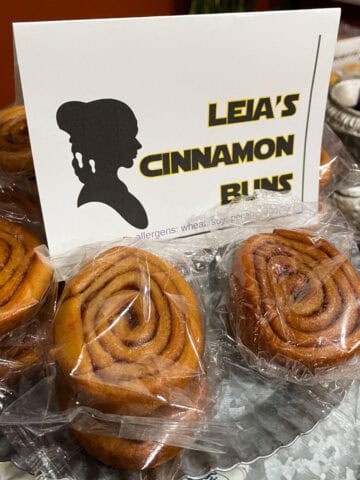 Star wars party tray with cinnamon swirls and a sign that says "Leia's cinnamon buns"