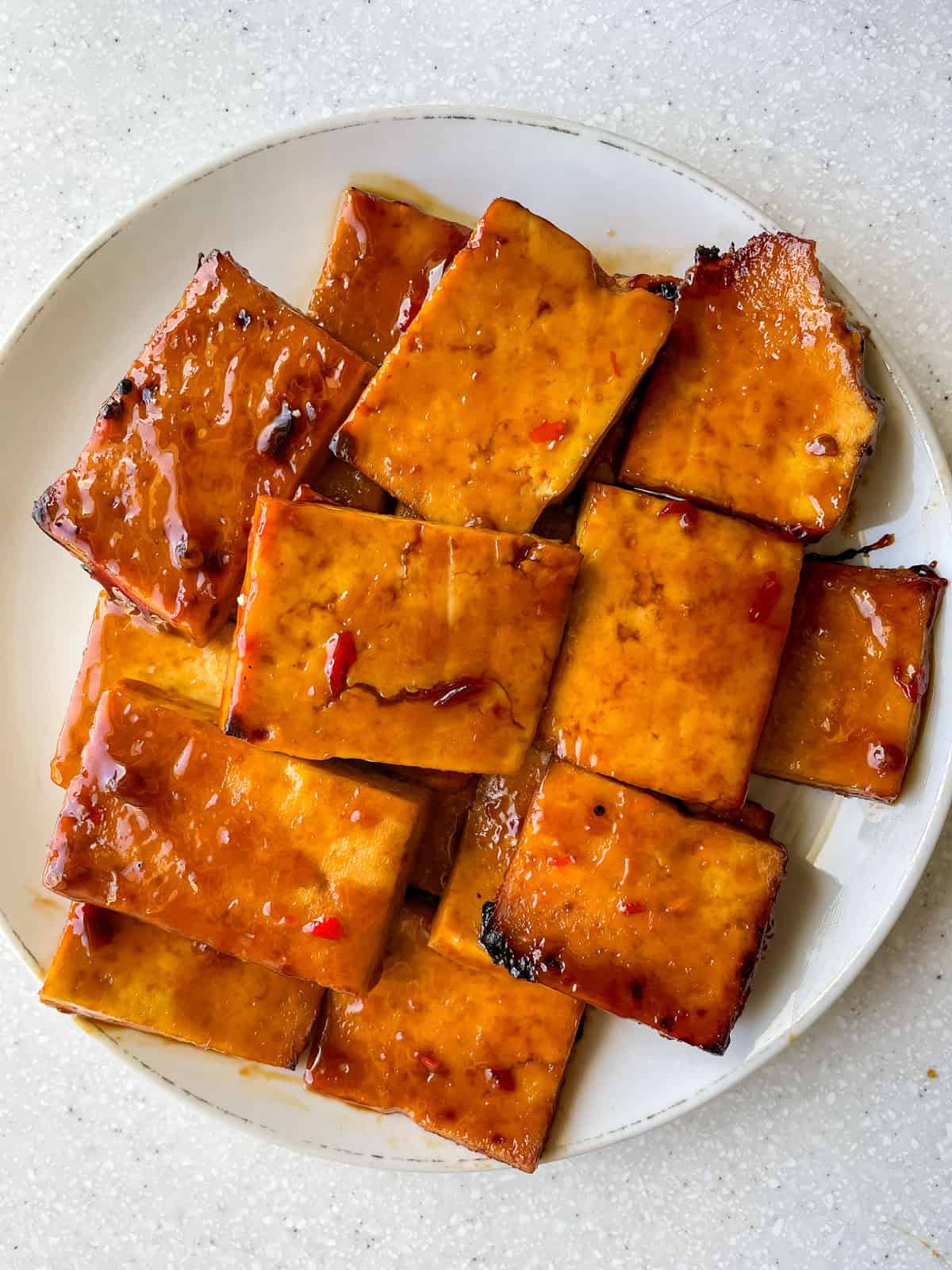 Finished Sweet Chili Air Fryer Tofu Slices on white plate