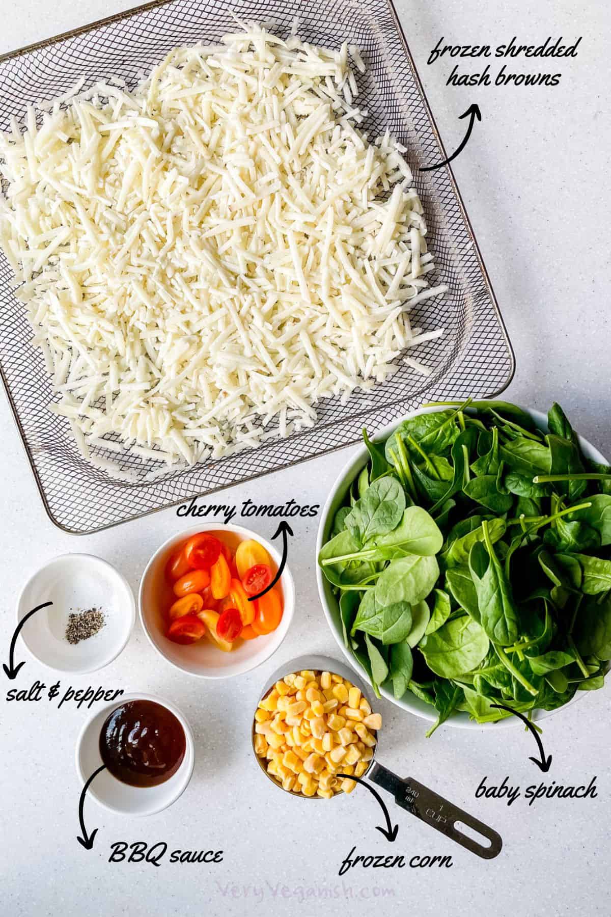 Ingredients for air fryer hash browns with veggies: frozen shredded potatoes from Aldi, baby spinach, cherry tomatoes, frozen corn, salt, black pepper and BBQ sauce