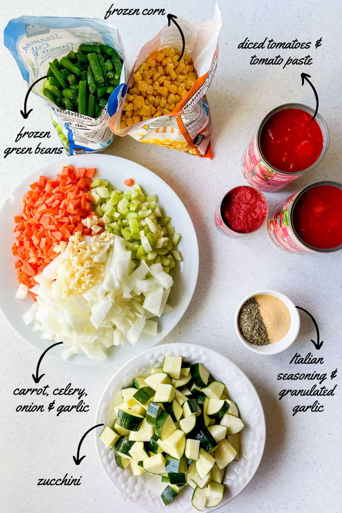 Ingredients to make tomato vegetable soup: diced tomatoes, tomato paste, frozen green beans, frozen corn, onion, garlic, carrot, celery, zucchini, italian seasoning and granulated garlic