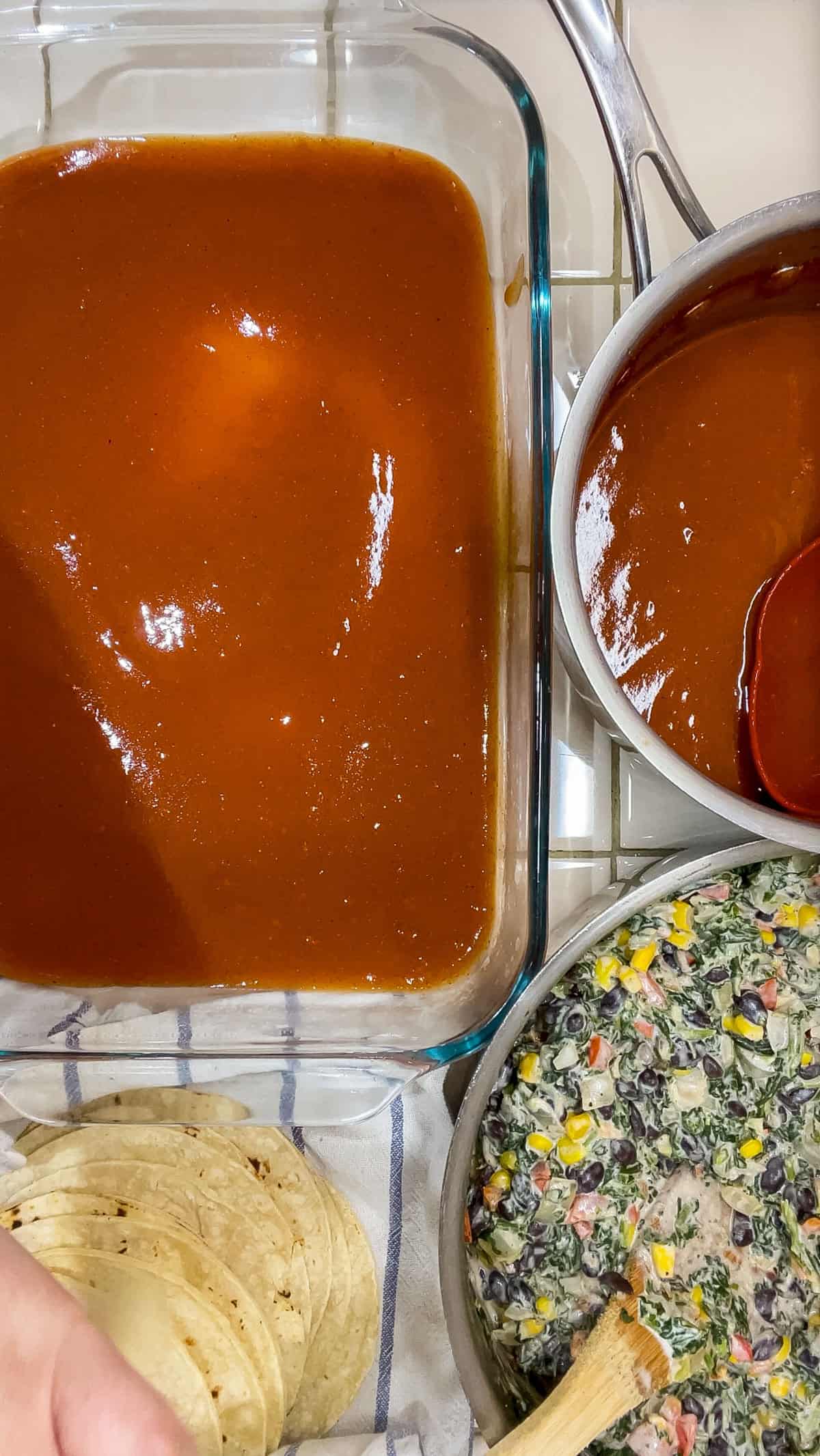 Process pour enchilada sauce on bottom of 13x9 pan