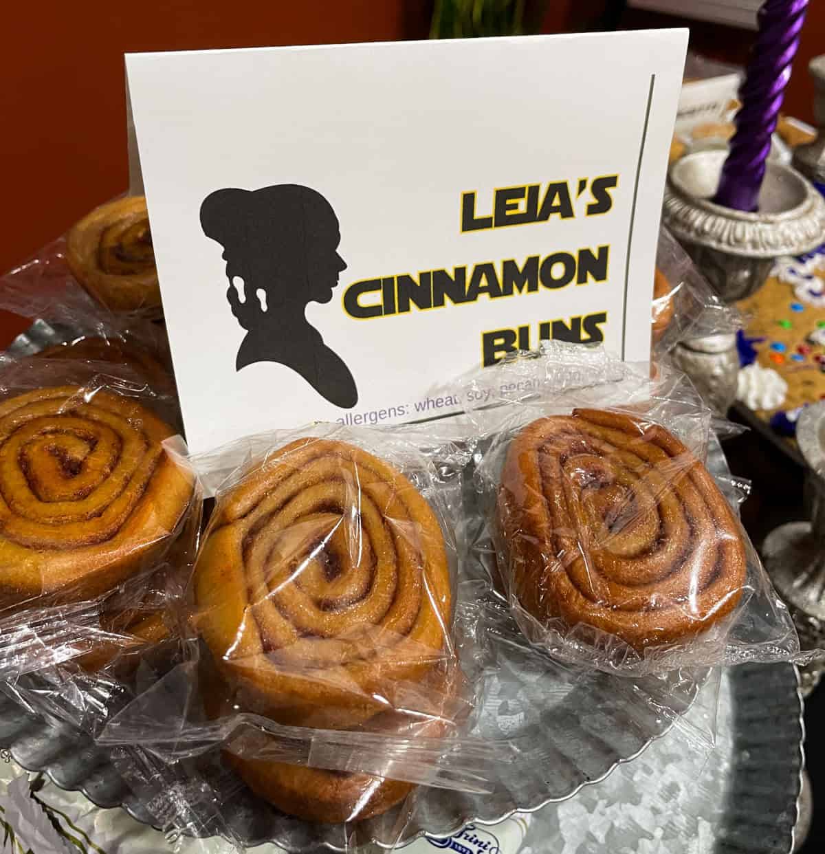 Star wars party tray with cinnamon swirls and a sign that says "Leia's cinnamon buns"