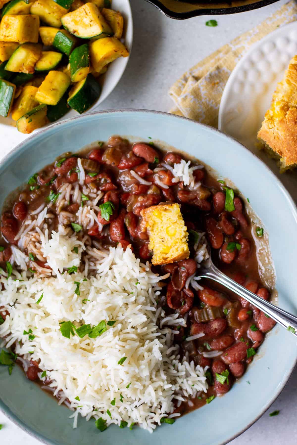 bowl of vegan red beans and rice with cornbread
