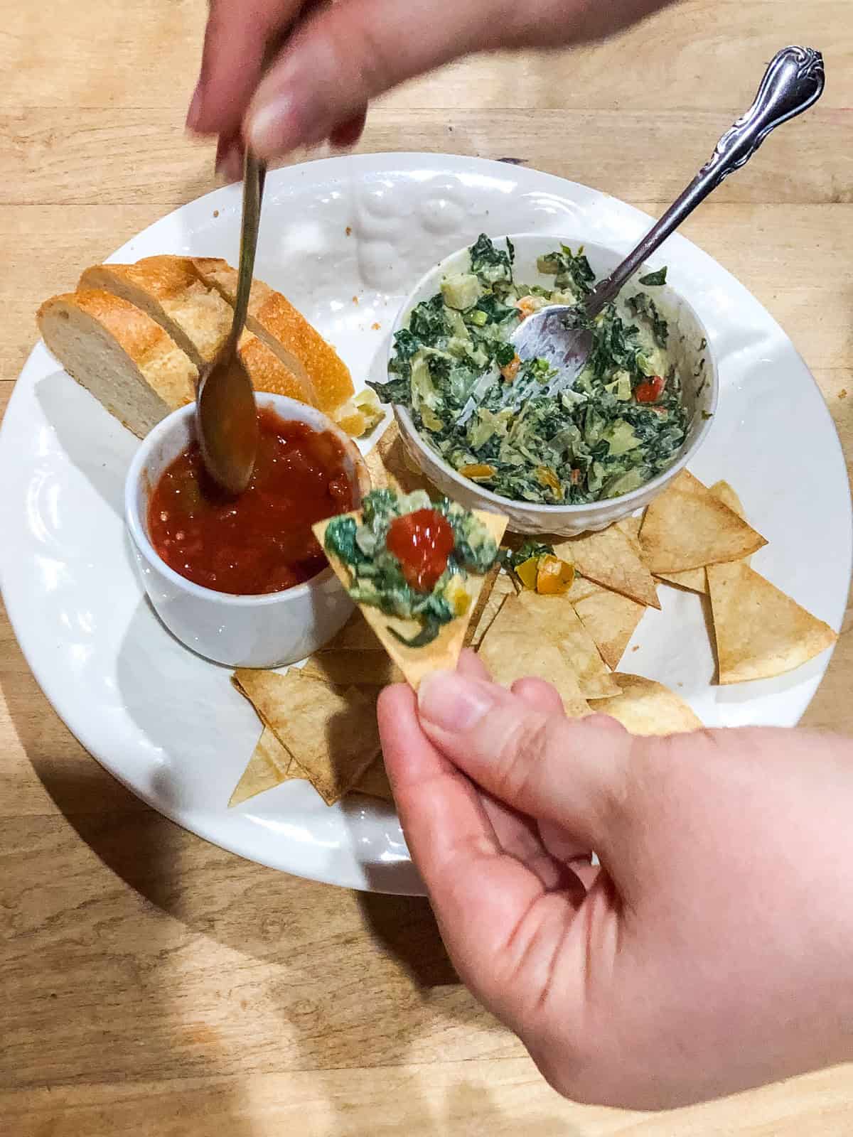 Serving up spinach artichoke dip with tortilla chips, salsa and toast