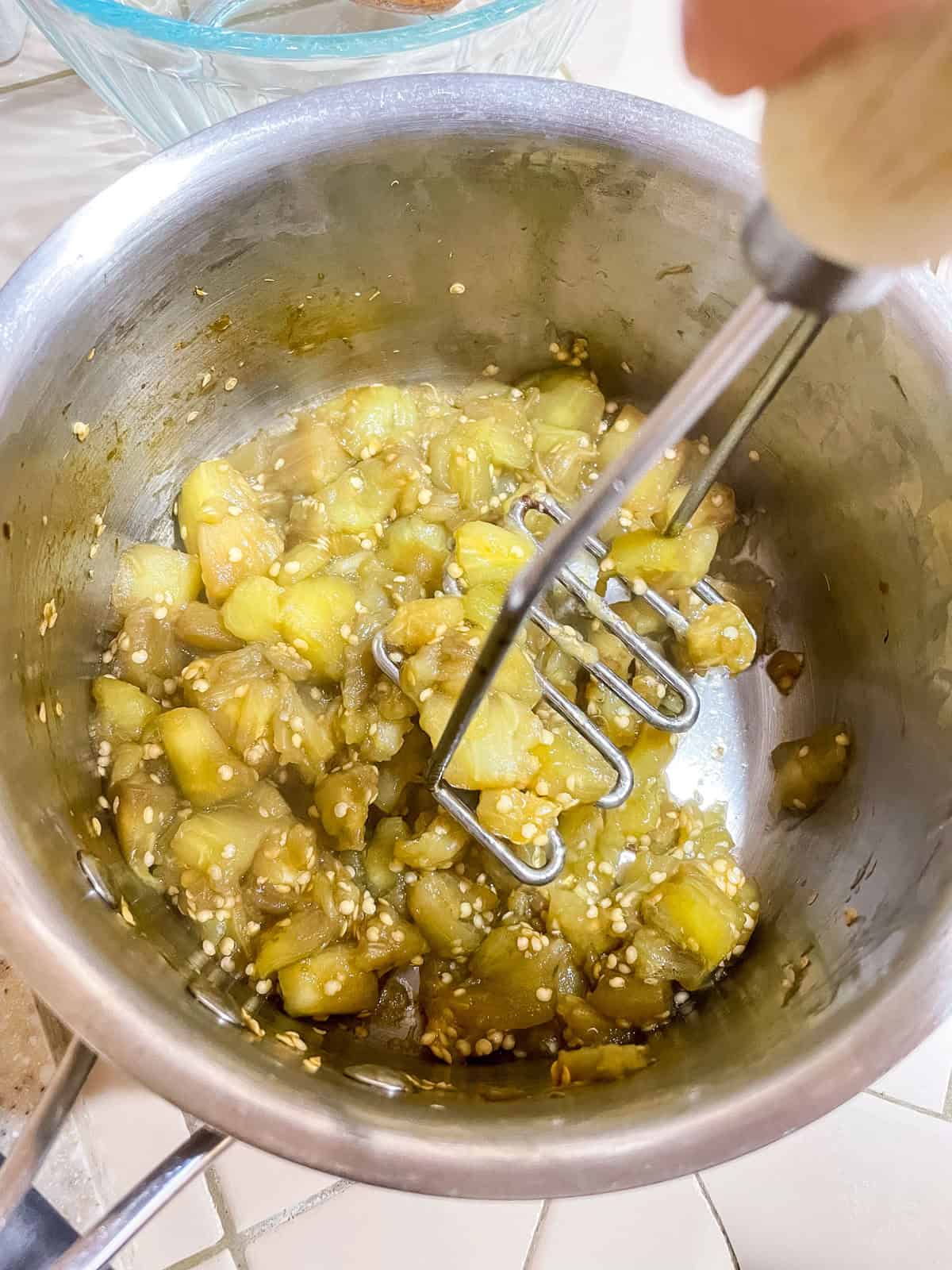 Process step 4 mash eggplant with potato masher