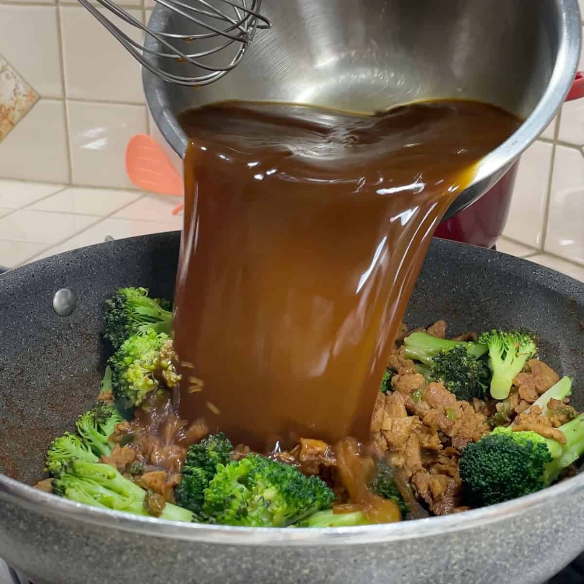 Process step 8 - whisk one more time and pour sauce into wok