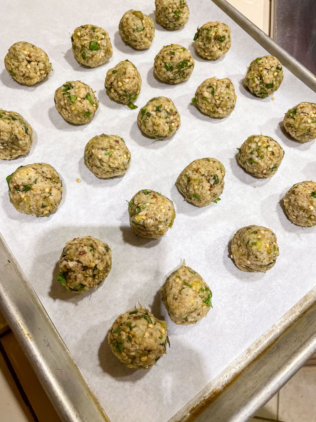 Process step 9 - line a baking sheet with parchment paper and place meatballs on parchment