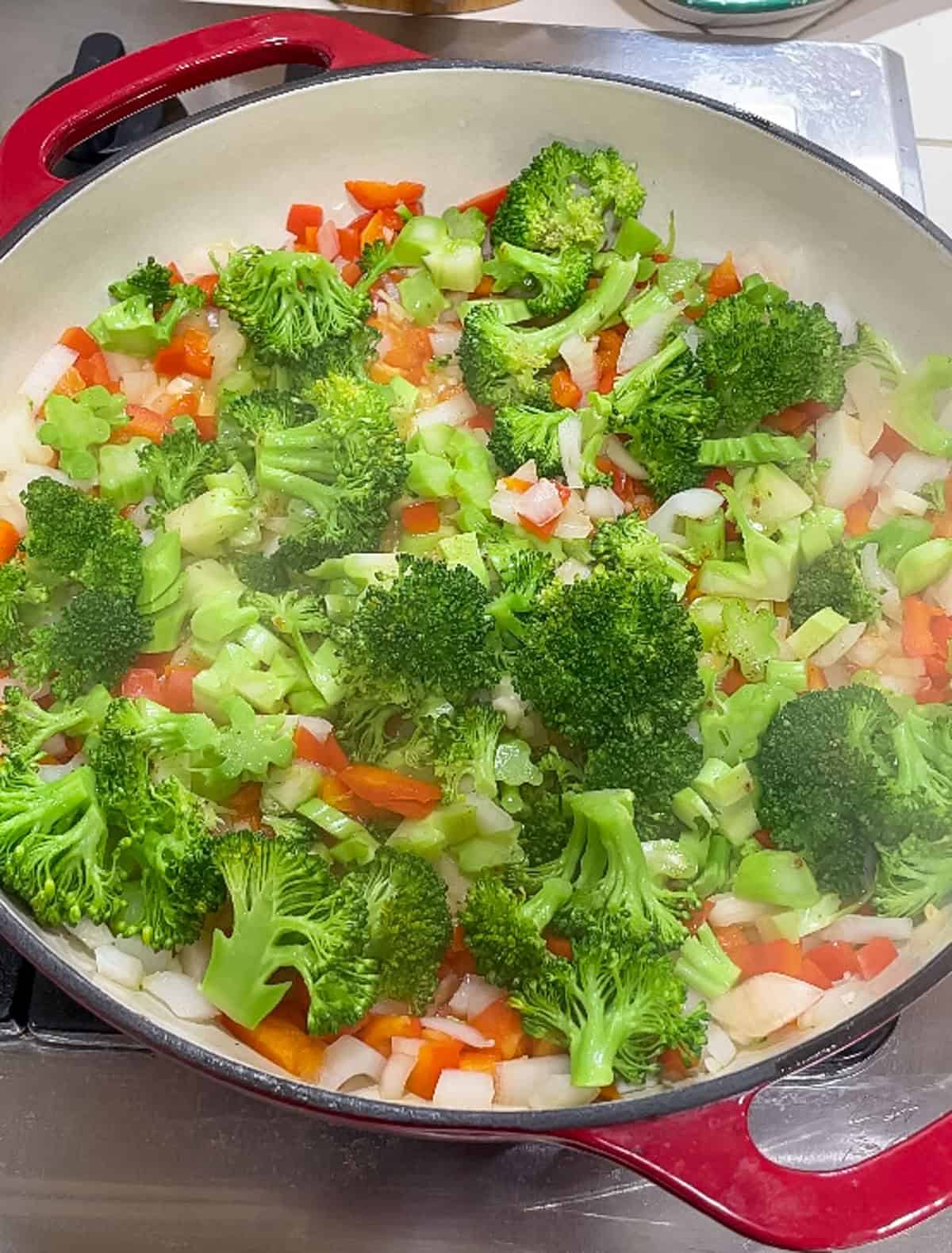 Process shot of steaming broccoli until bright green in the skillet