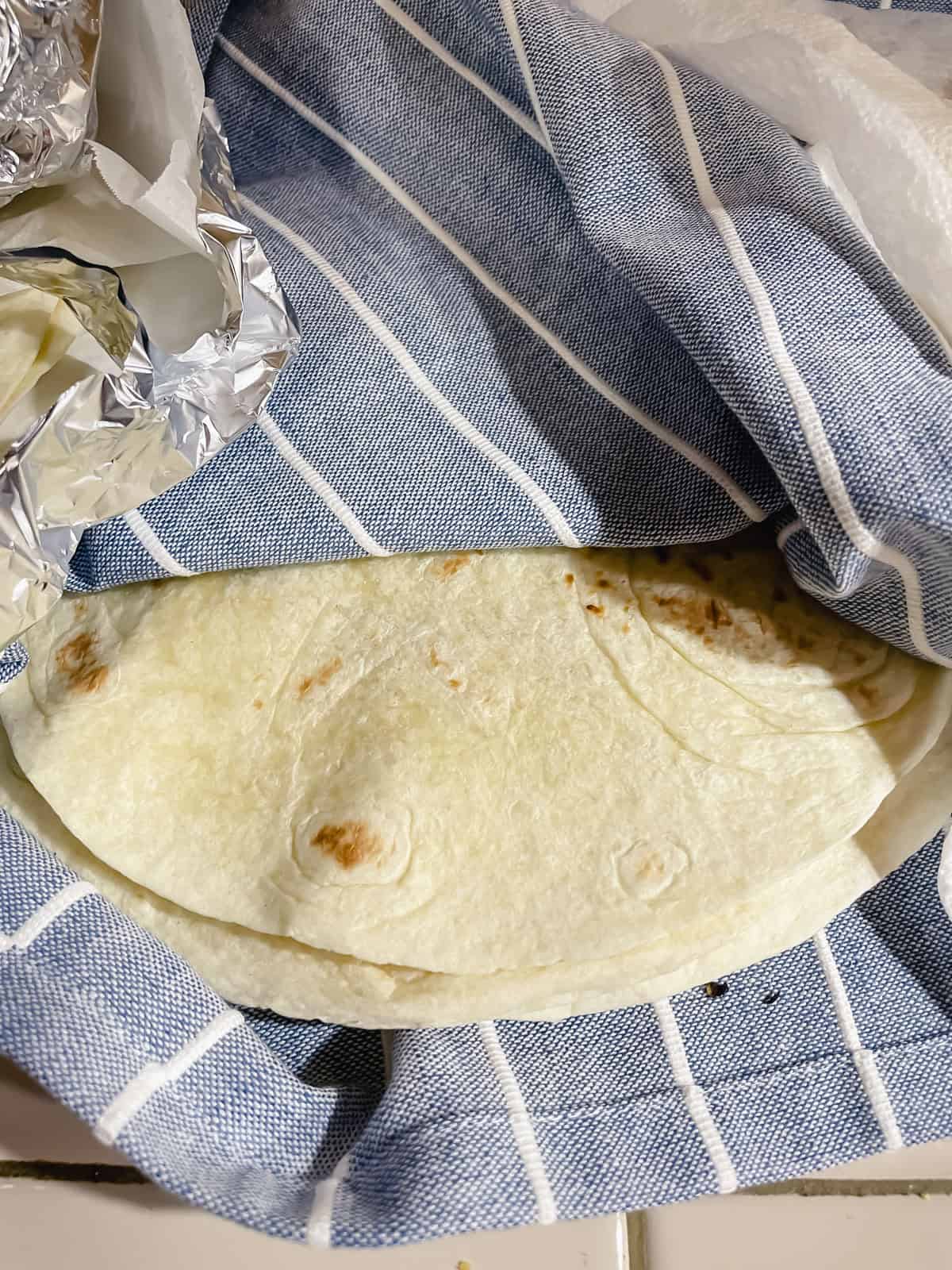 Flour tortillas (heated over open flame and put inside tea towel to keep warm)
