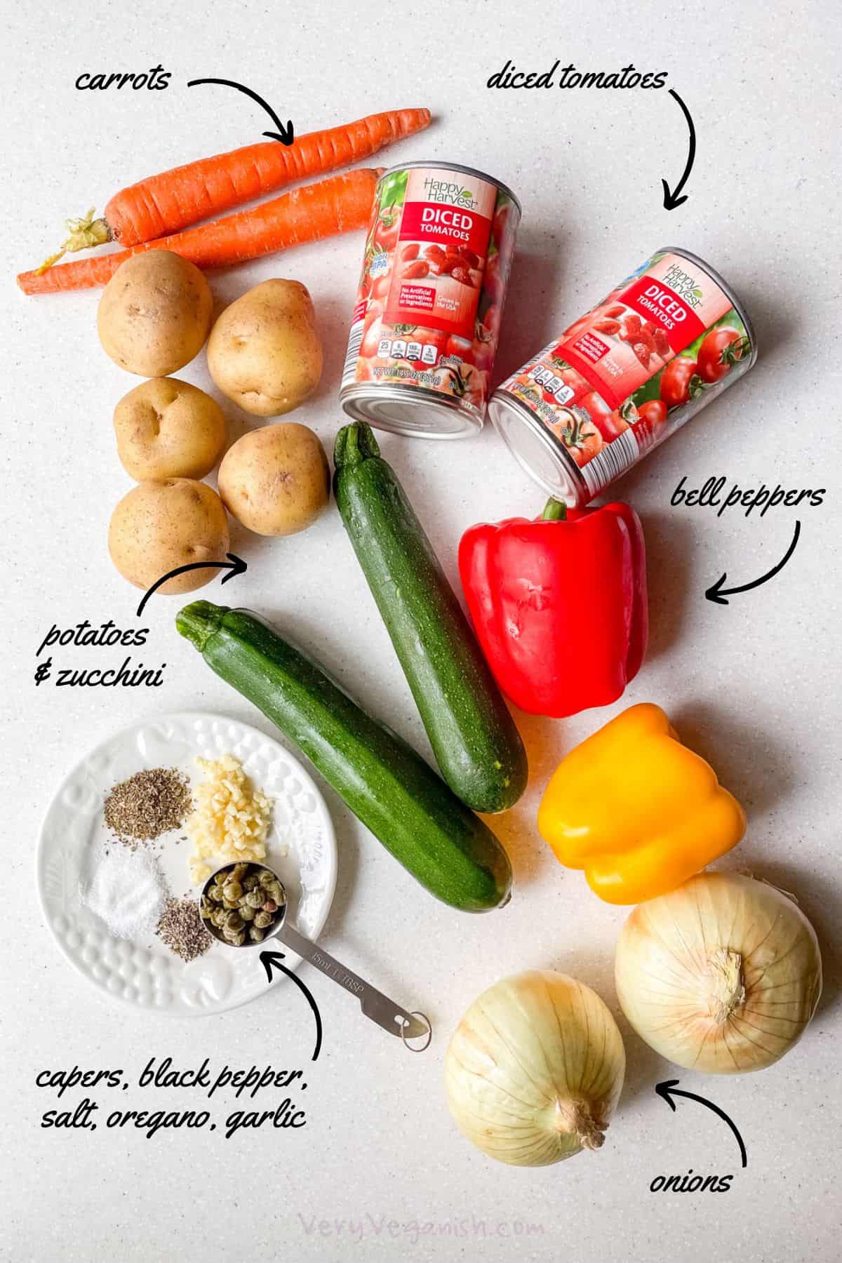 Ingredients for Mediterranean Vegetable Potato Stew Recipe: diced tomatoes, bell peppers, onion, zucchini, potato, carrot, capers, garlic, oregano, salt and pepper