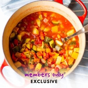 Red dutch oven full of vegetable potato stew and ladle with words "members only exclusive" overlaid