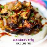 plate with roasted BBQ eggplant and onion on a bed of mashed potatoes with BBQ sauce drizzled on top - label reads "members only exclusive"