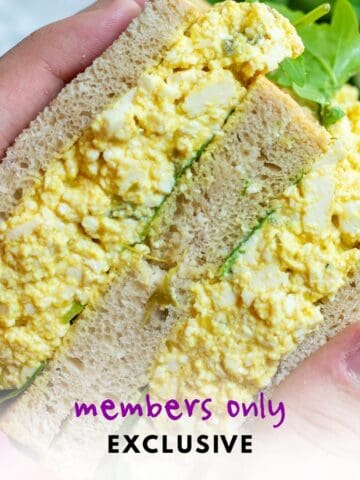 Holding a tofu egg salad sandwich