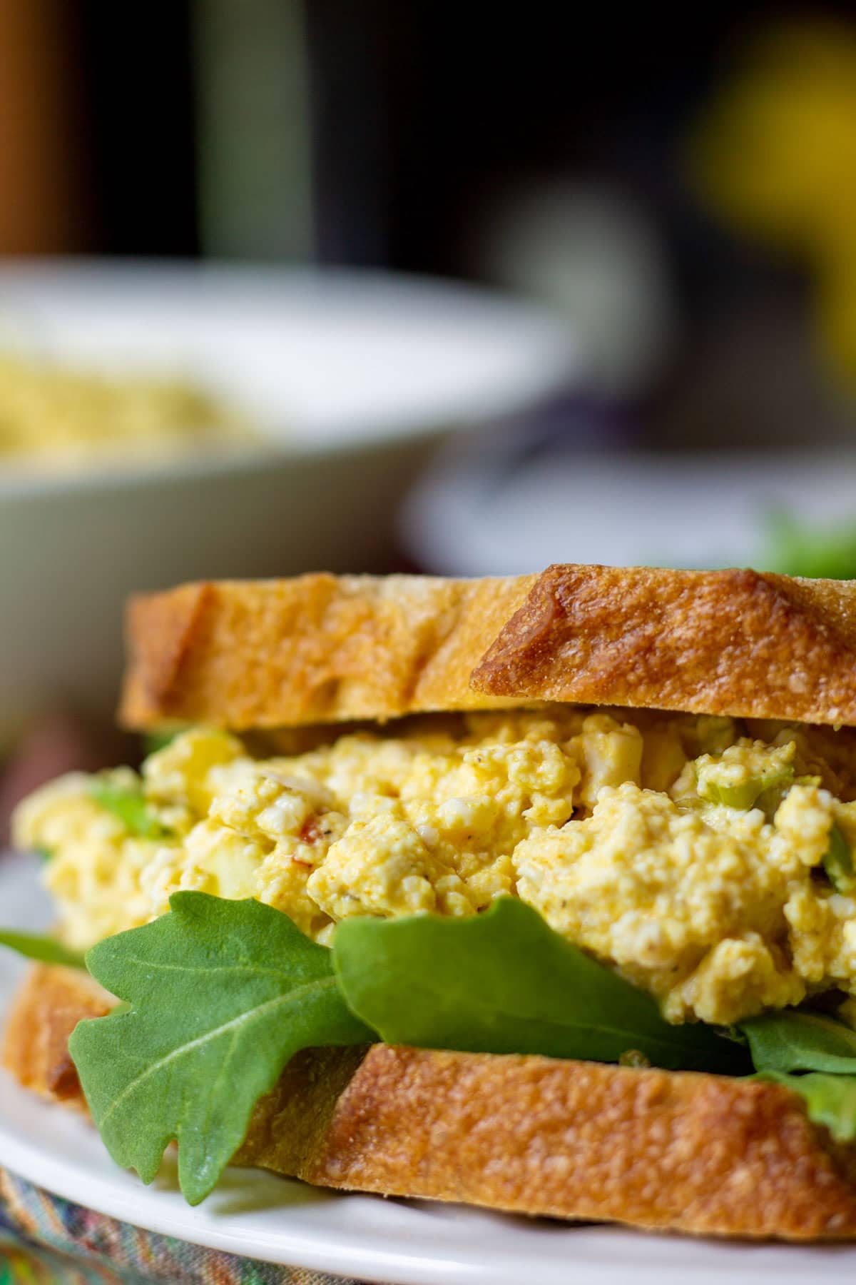 Prepared tofu egg salad sandwich on white plate