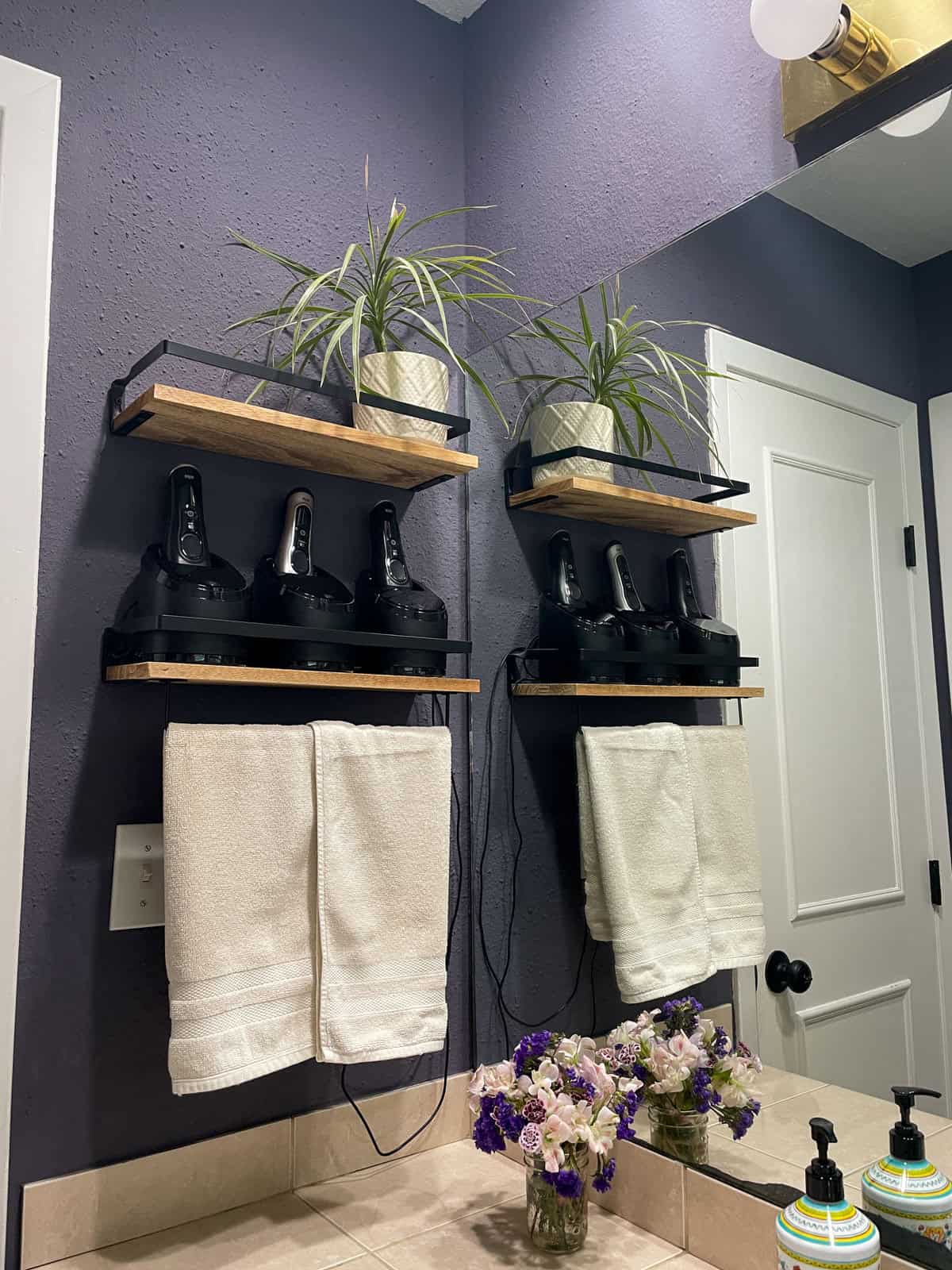 Floating wood shelves with plants and towels mounted on a textured bathroom wall painted with James Alexander Natural Paint after one year.