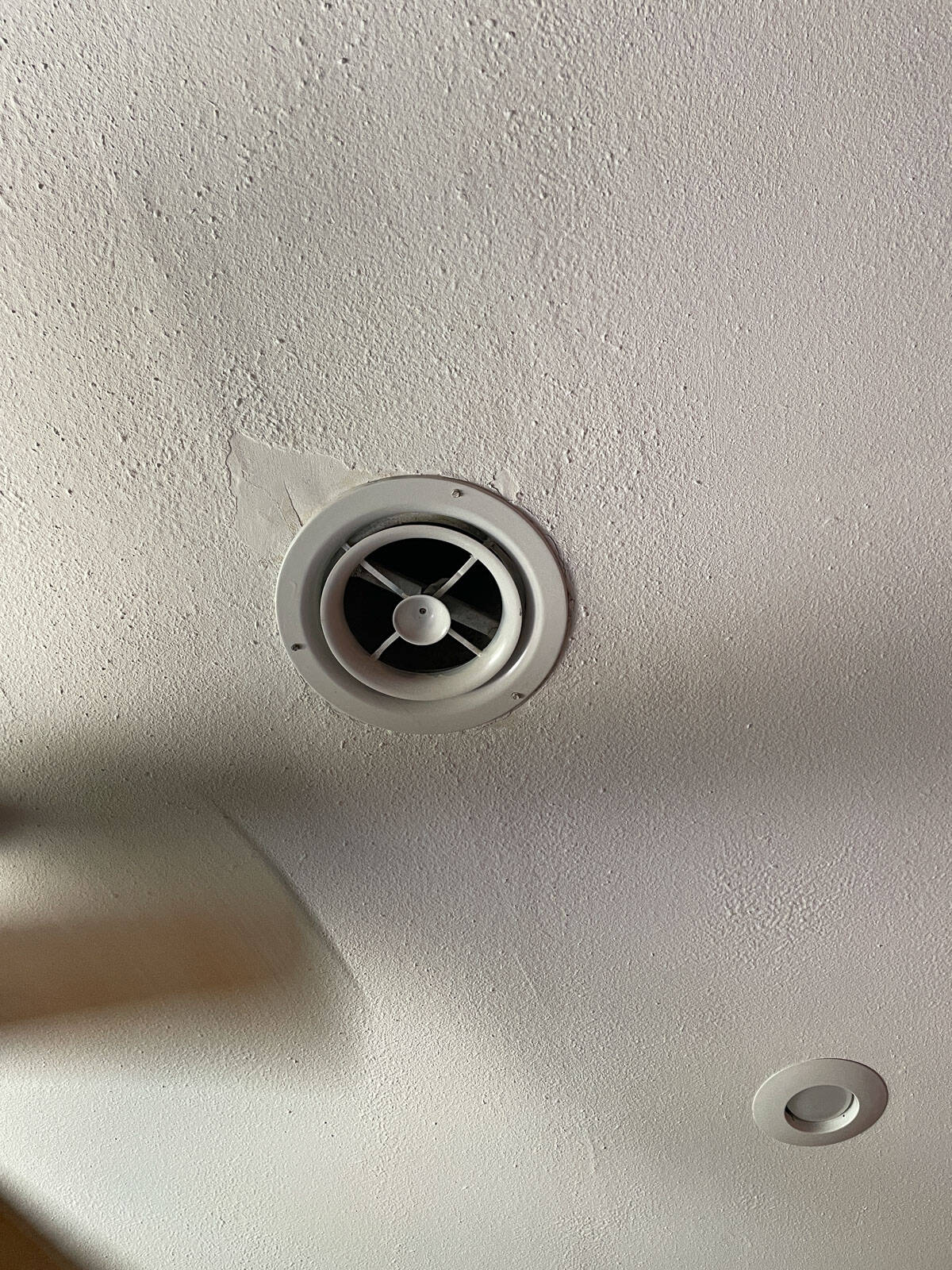 Close-up of a ceiling air vent surrounded by James Alexander Natural Paint, demonstrating how the natural paint has held up after one year.
