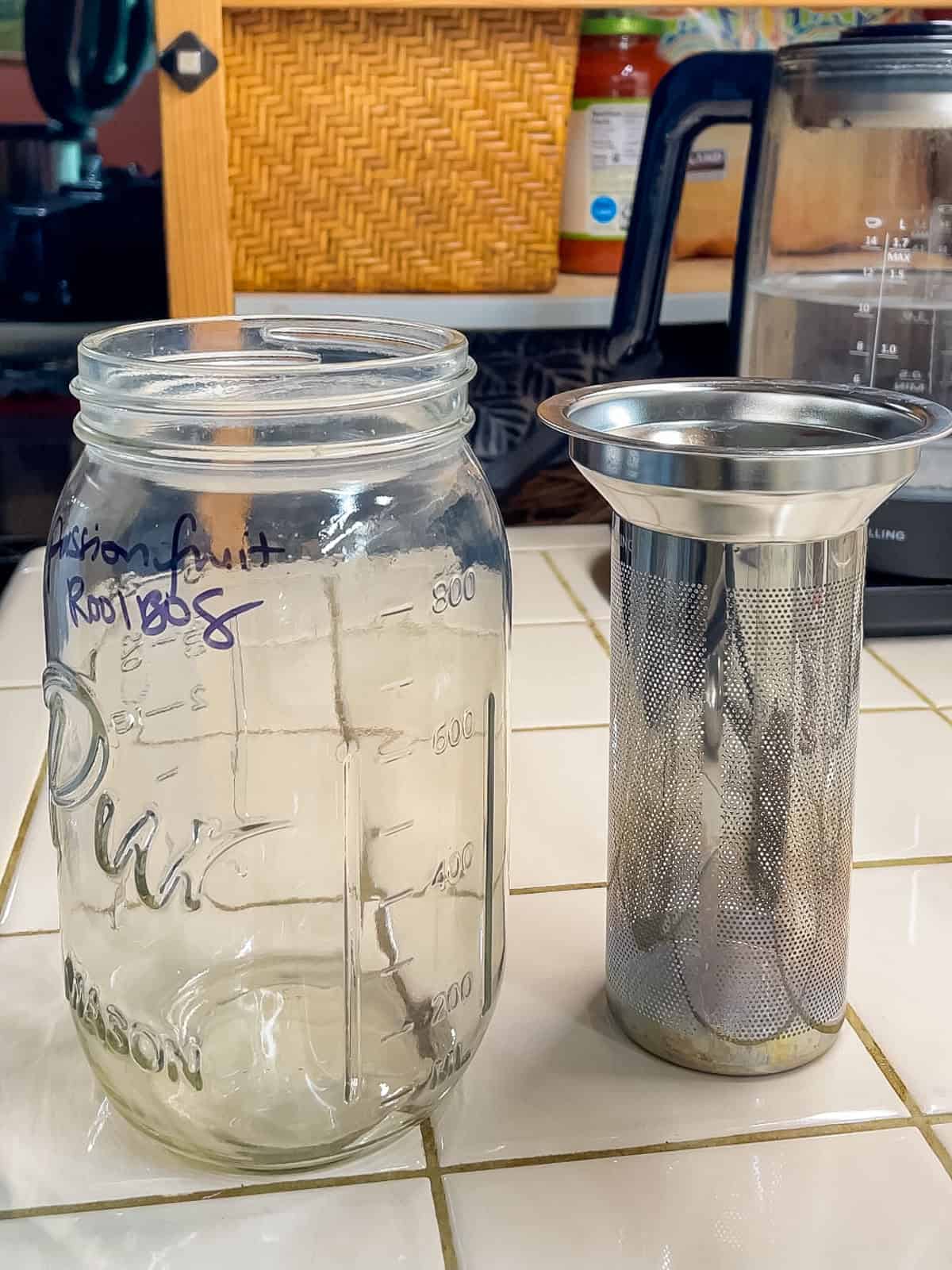 Mason jar and stainless steel tea infuser basket used to make rooibos iced tea with loose leaf tea.